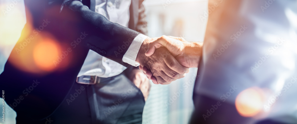 Businessman handshake for teamwork of business merger and acquisition,successful negotiate,hand shake,two businessman shake hand with partner to celebration partnership and business deal concept - obrazy, fototapety, plakaty 