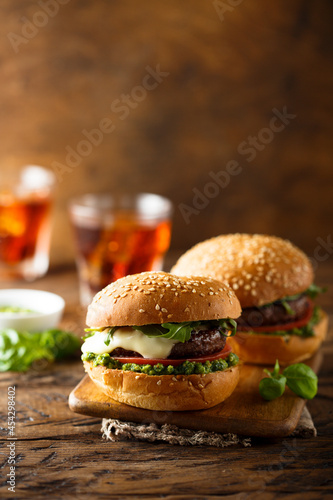 Traditional homemade beef burgers with pesto sauce