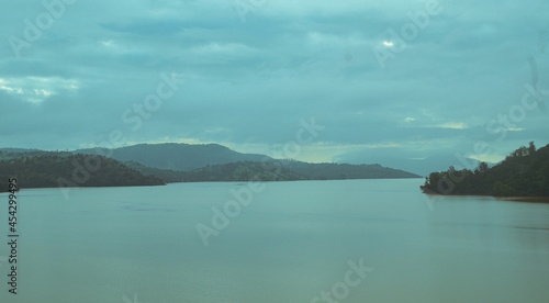 Dramatic Scenic view of a dam backwater with a very cloudy and rainy evening © Rohan