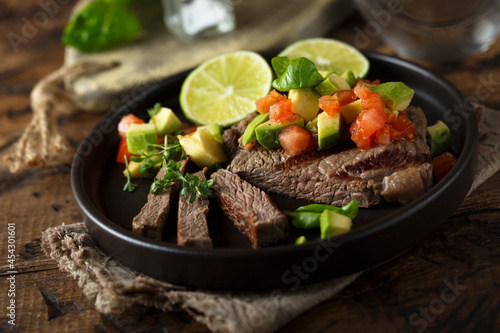 Grilled beef steak with avocado salsa