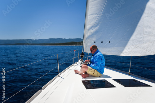 Man working on sail yacht
