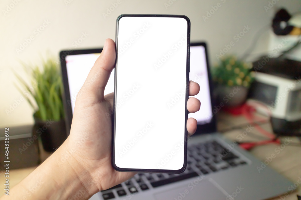Man's hands holding or using smartphone with two hands. Smartphone with white blank on screen, Cellphone mockup. Man's hands holding or using smartphone with two hands. Smartphone with white blank on screen, Cellphone mockup.