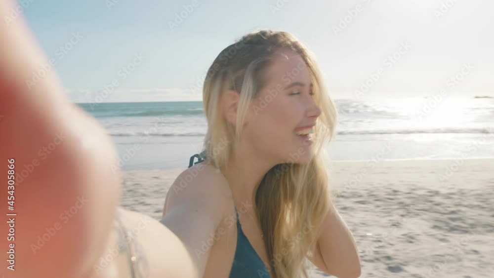 beautiful woman having video chat on beach girl waving at camera sharing summer vacation using smartphone showing travel adventure having fun on holiday beautiful woman having video chat on beach girl waving at camera sharing summer vacation using smartphone showing travel adventure having fun on holiday
