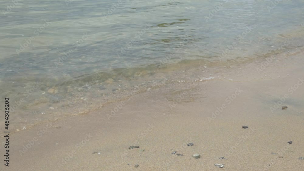 Slow motion, Surf. Transparent waves of the surf run over the sandy beach. Siberia, the Ob River. Slow motion, Surf. Transparent waves of the surf run over the sandy beach. Siberia, the Ob River.