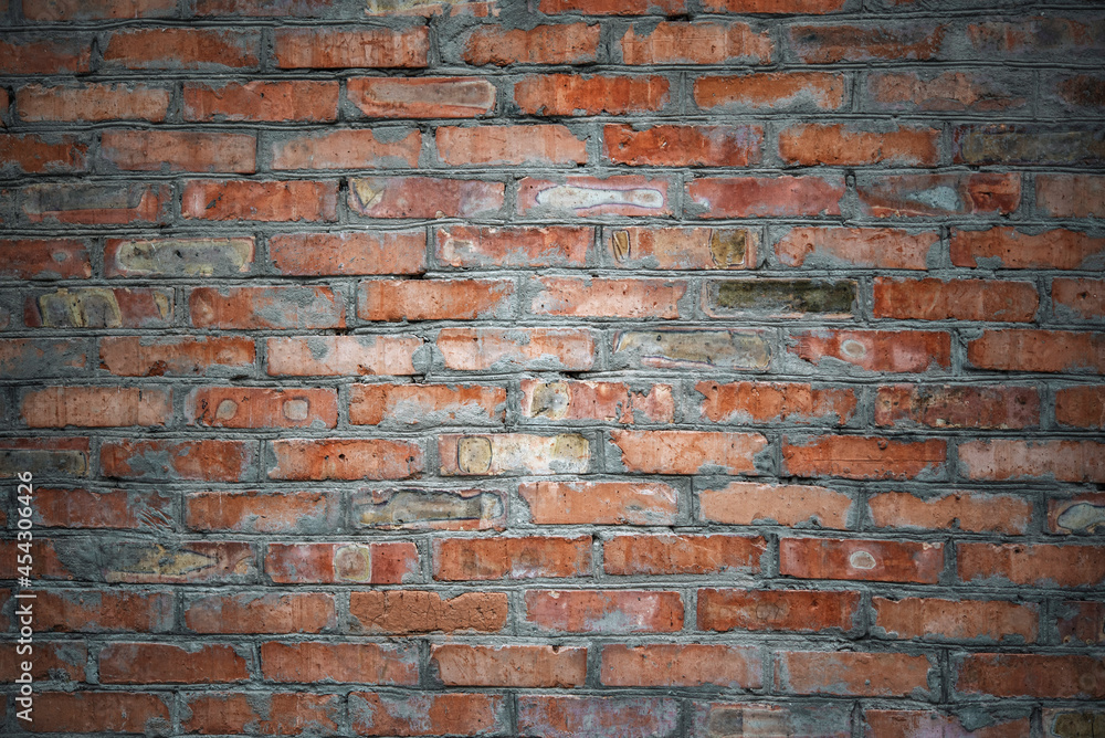 Naklejka premium Red clay old brick wall background, weather staines old brick texture