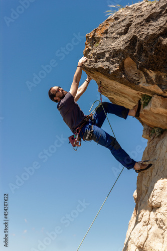 man practicing sport rock climbing