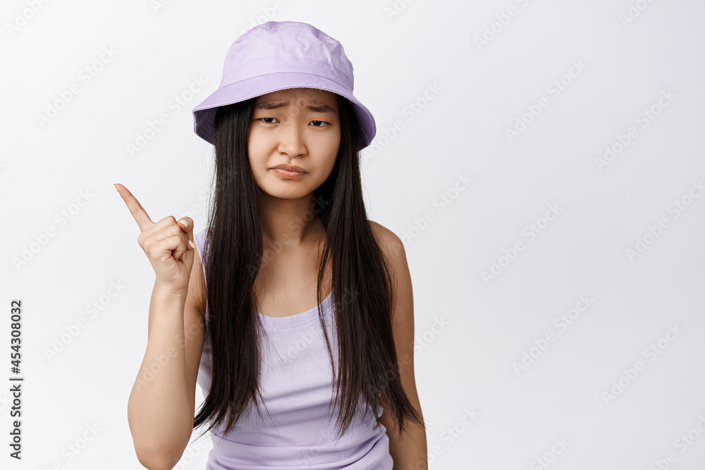 Young asian woman give warning, shaking finger and looking disappointed, scolding someone, standing over white background Young asian woman give warning, shaking finger and looking disappointed, scolding someone, standing over white background
