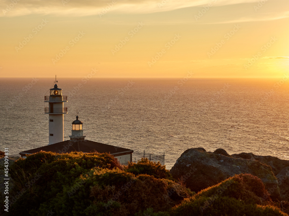Tourinan Lighthouse in Muxia, Galician coast, Spain. Twice a year, at the beginning of spring and the end of summer, Cape Touriñan becomes the last shadow for the sunset in continental Europe.
