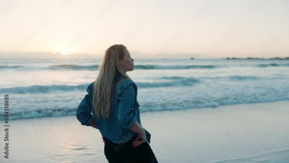 young woman alone on beach looking at sunset on ocean horizon thinking of journey contemplating life enjoying peaceful summer vacation freedom young woman alone on beach looking at sunset on ocean horizon thinking of journey contemplating life enjoying peaceful summer vacation freedom