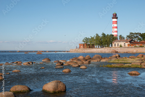 Leningrad region, Russia - 20 August 2020: Shepelevsky lighthouse on the background of the Gulf of Finland on a sunny day. photo