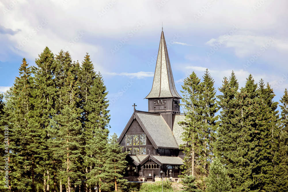 exterior of Holmenkollen Chapel with blue sky in Norway