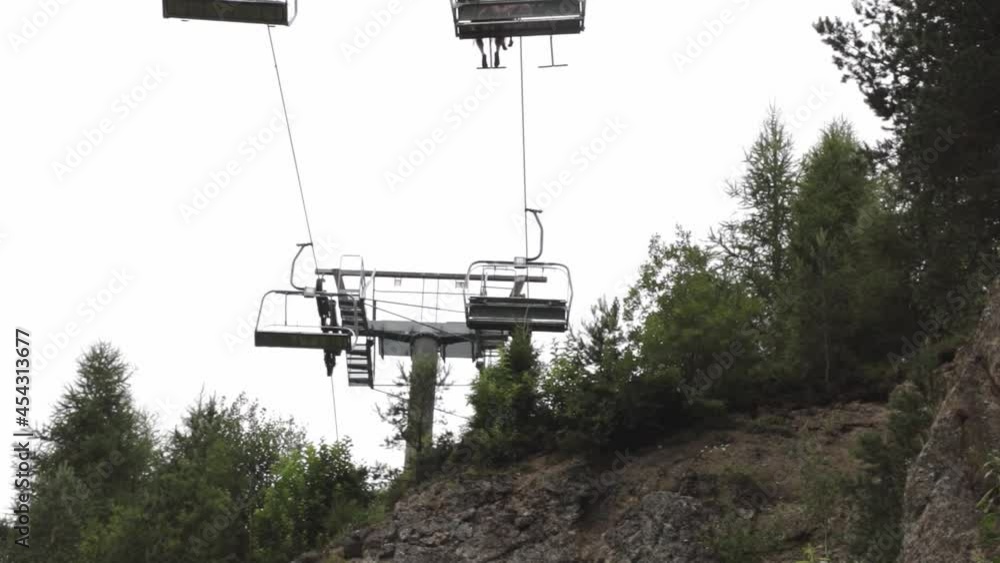 View from below of the moving cable car in the mountains View from below of the moving cable car in the mountains