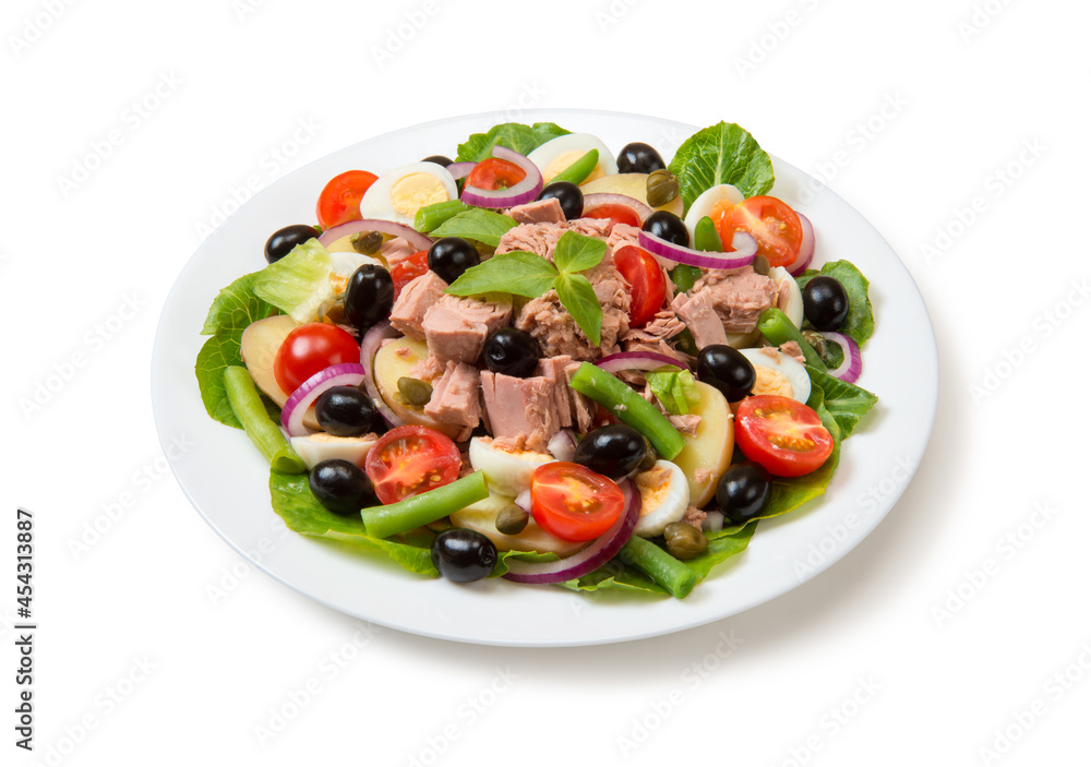 Nicoise salad with tuna, tomatoes, lettuce, olives in a white plate isolated on white background. Close-up. Nicoise salad with tuna, tomatoes, lettuce, olives in a white plate isolated on white background. Close-up.