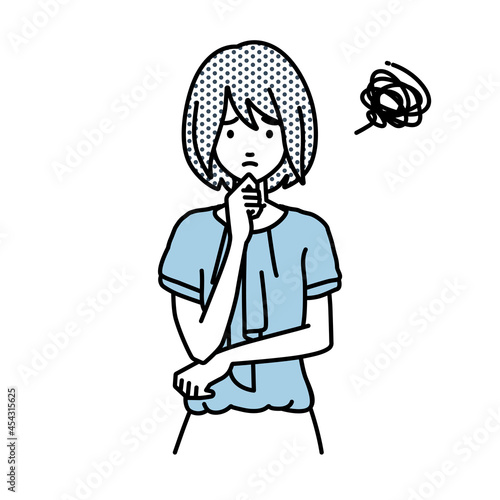 立って手をあごにあてて困っているオフィスカジュアルの女性