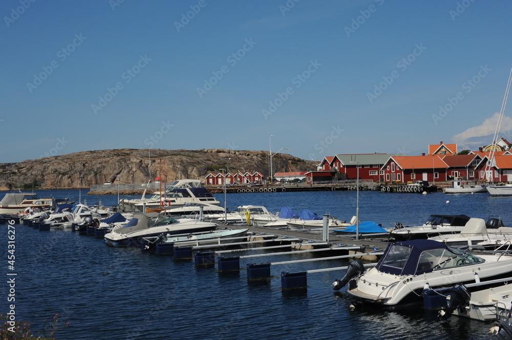 Scenic panorama of a waterfront with boats, yachts and houses in Kungshamn (Sotenäs, Västra Götaland, Sweden) on a sunny day in summer