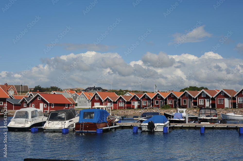 Fototapeta premium Scenic panorama of a waterfront with boats, yachts and houses in Kungshamn (Sotenäs, Västra Götaland, Sweden) on a sunny day in summer