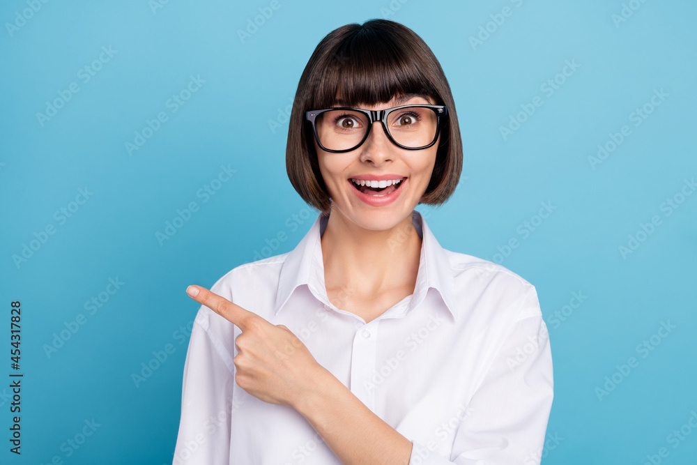 Portrait of attractive amazed cheerful girl demonstrating copy space novelty offer advert isolated over bright blue color background Portrait of attractive amazed cheerful girl demonstrating copy space novelty offer advert isolated over bright blue color background