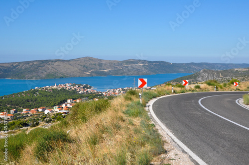 Croatian landscape with mountains, sea, town in the valley and road