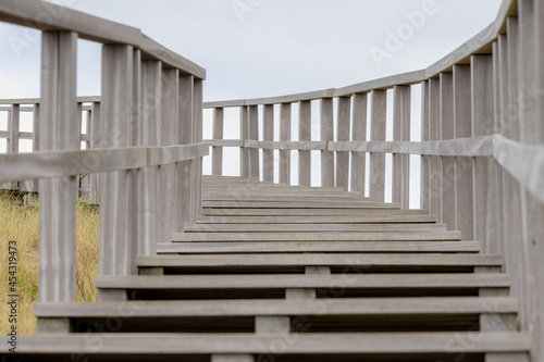 Structure and curve of wooden stairs and rails with selective focus, Outdoor wood ladder to the viewpoint, Petten is a town in the Dutch province of North Holland, Municipality of Schagen, Netherlands