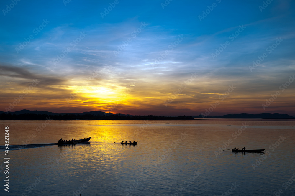 Myanmar. Mon State. Mawlamyine (Moulmein). Fishermen on the Salouen river at sunset Myanmar. Mon State. Mawlamyine (Moulmein). Fishermen on the Salouen river at sunset