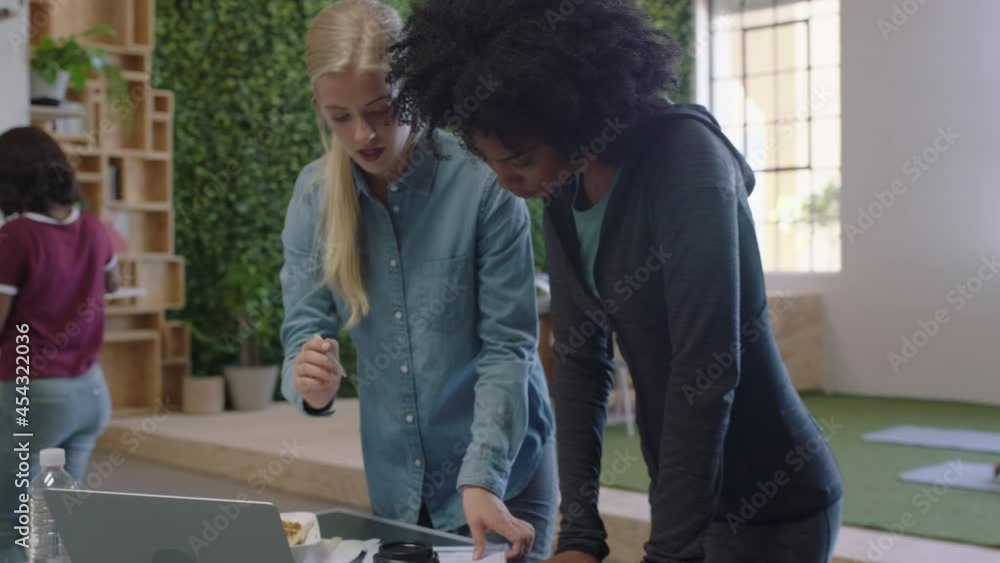 young business women brainstorming working together sharing ideas collaborating on project enjoying teamwork in modern office workplace young business women brainstorming working together sharing ideas collaborating on project enjoying teamwork in modern office workplace