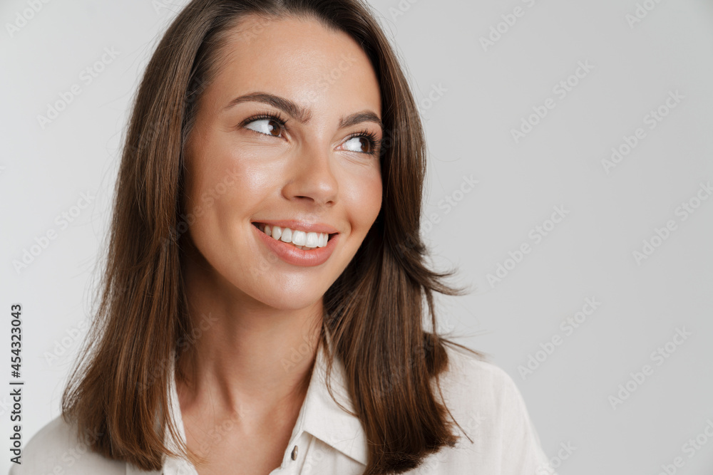 Young european woman in shirt smiling and looking aside Young european woman in shirt smiling and looking aside