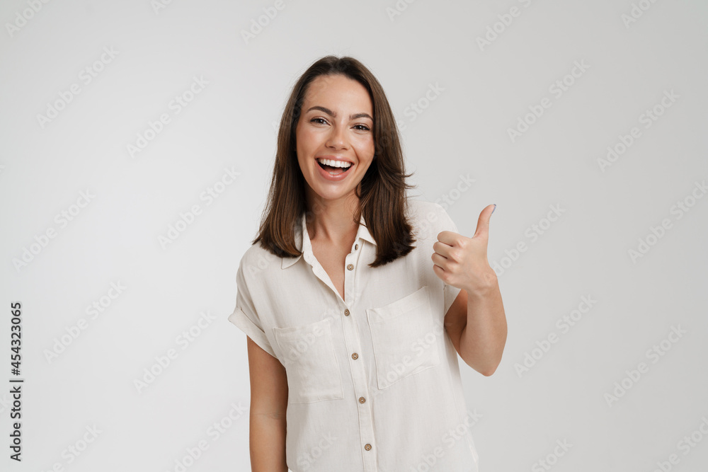 Young european woman smiling and showing thumb up Young european woman smiling and showing thumb up