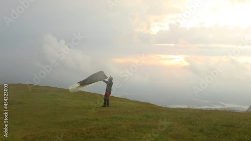 Wallpaper Mural Hiker on the mountain peak at the sunrise with his tent Torontodigital.ca