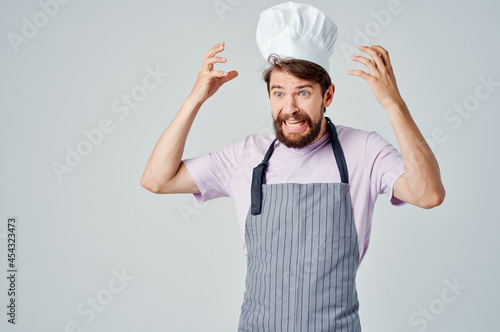 bearded male chef work in a restaurant industry cooking