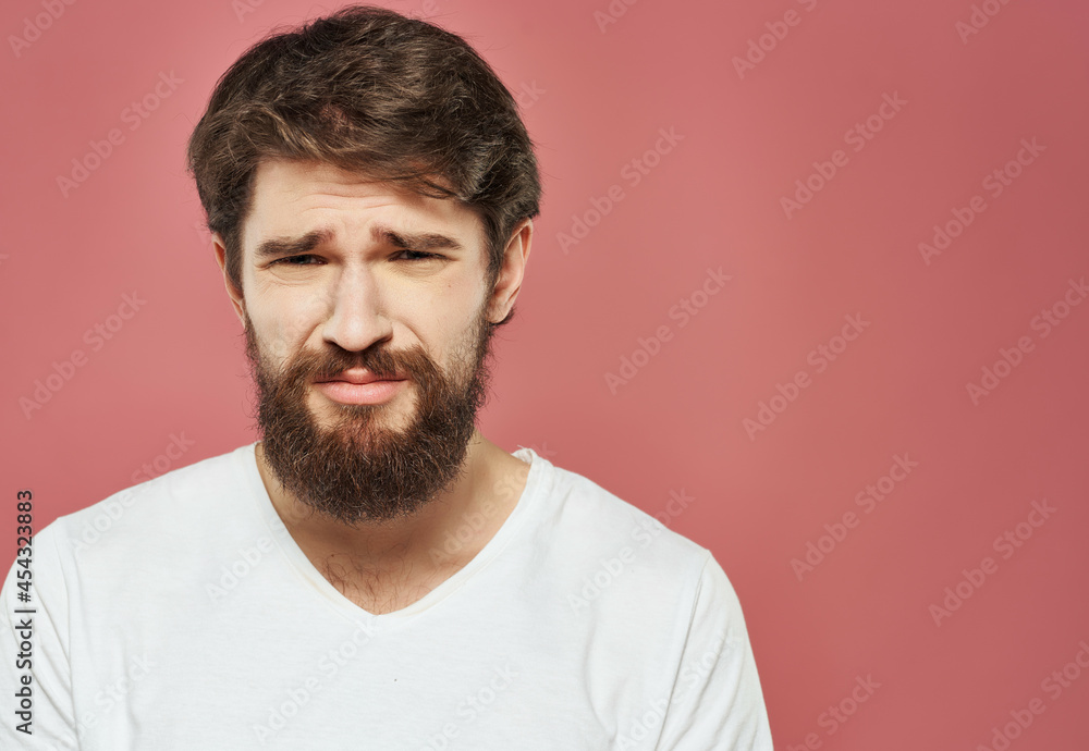 emotional man in a white t-shirt irritated facial expression Lifestyle emotional man in a white t-shirt irritated facial expression Lifestyle