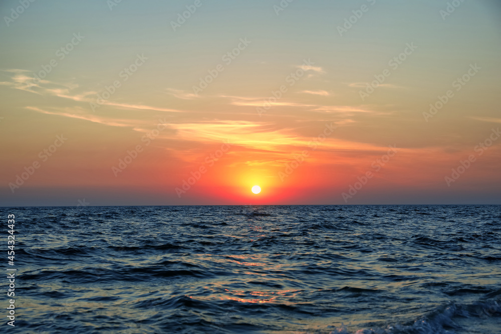 Beautiful sky with sun over sea at sunset