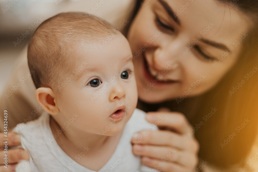 authentic portrait of a newborn daughter in the arms of the mother. The woman rejoices, embraces and kisses a child speaks his daughter is happy, happy maternity authentic portrait of a newborn daughter in the arms of the mother. The woman rejoices, embraces and kisses a child speaks his daughter is happy, happy maternity