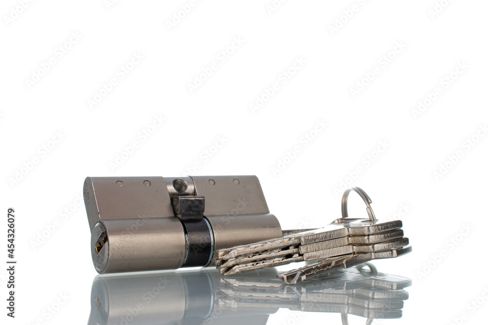 One lock core with keys, close-up isolated on white. One lock core with keys, close-up isolated on white.