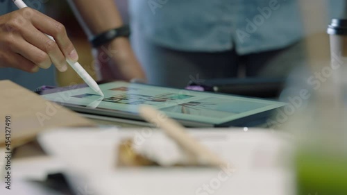 professional business people brainstorming graphic design team using tablet sharing ideas working together on creative project in development meeting close up hands
