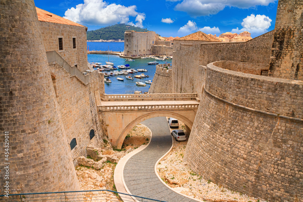 Summer cityscape - view of the bridge between the Revelin Fortress and the Ploce Gate in the Old Town of Dubrovnik on the Adriatic coast of Croatia