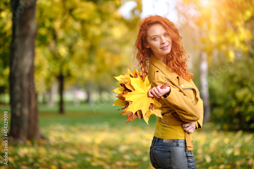 autumn woman on leafs. Park scene