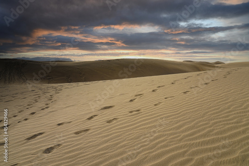 Sand dunes with a cloudy and dark sky