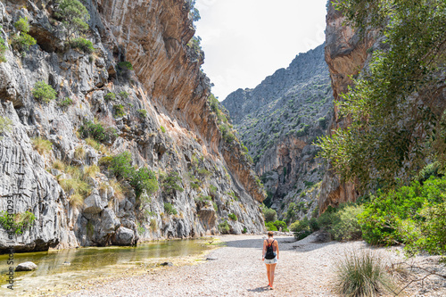 The girl walks through the gorge of Torrent de Pareis - the most beautiful canyon in Majorca photo