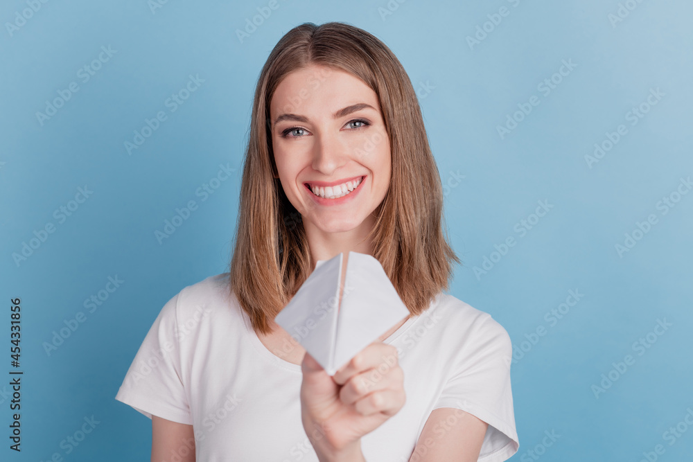 Portrait of cheerful nice attracitve lady hold send paper plane toothy smile on blue background Portrait of cheerful nice attracitve lady hold send paper plane toothy smile on blue background