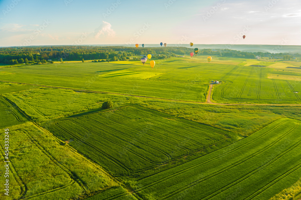 Fototapeta premium Aerial landscape view with colorful hot air balloons