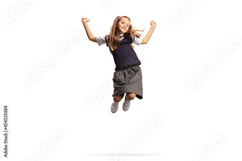 Happy schoolgirl in a uniform jumping