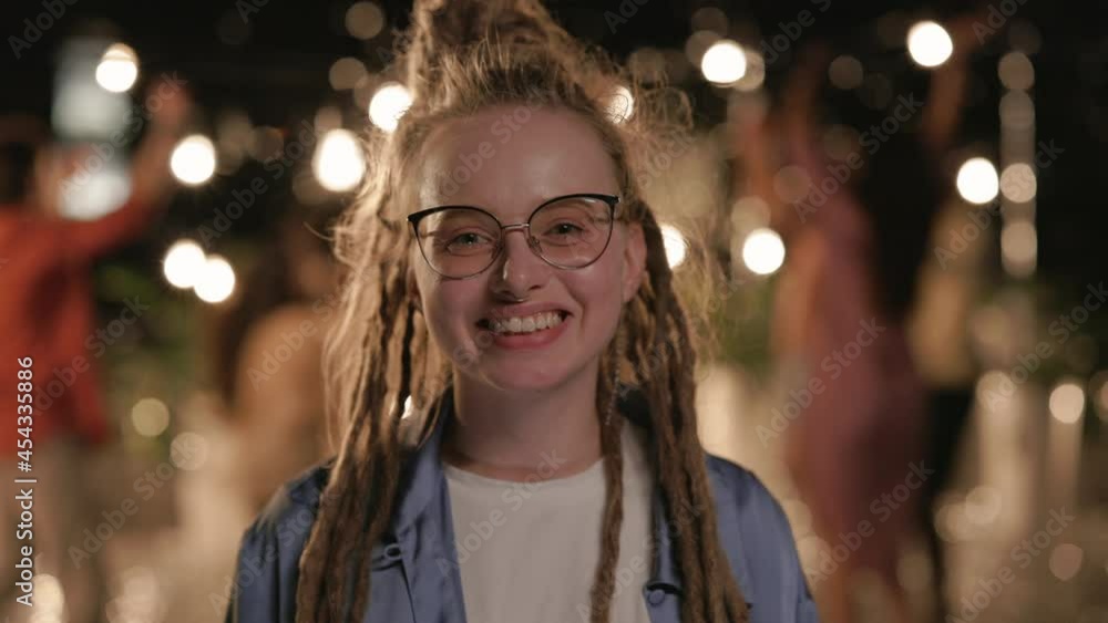 Portrait of woman with piercing and dreads posing on roof Portrait of woman with piercing and dreads posing on roof