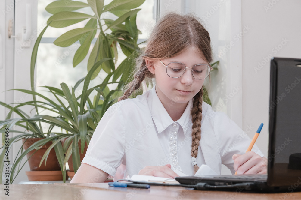 Portrait of female student enjoying learning in coworking office using laptop computer for research, freelancer during making project for remote job making notes. Pupil concentrated drawing notes Portrait of female student enjoying learning in coworking office using laptop computer for research, freelancer during making project for remote job making notes. Pupil concentrated drawing notes