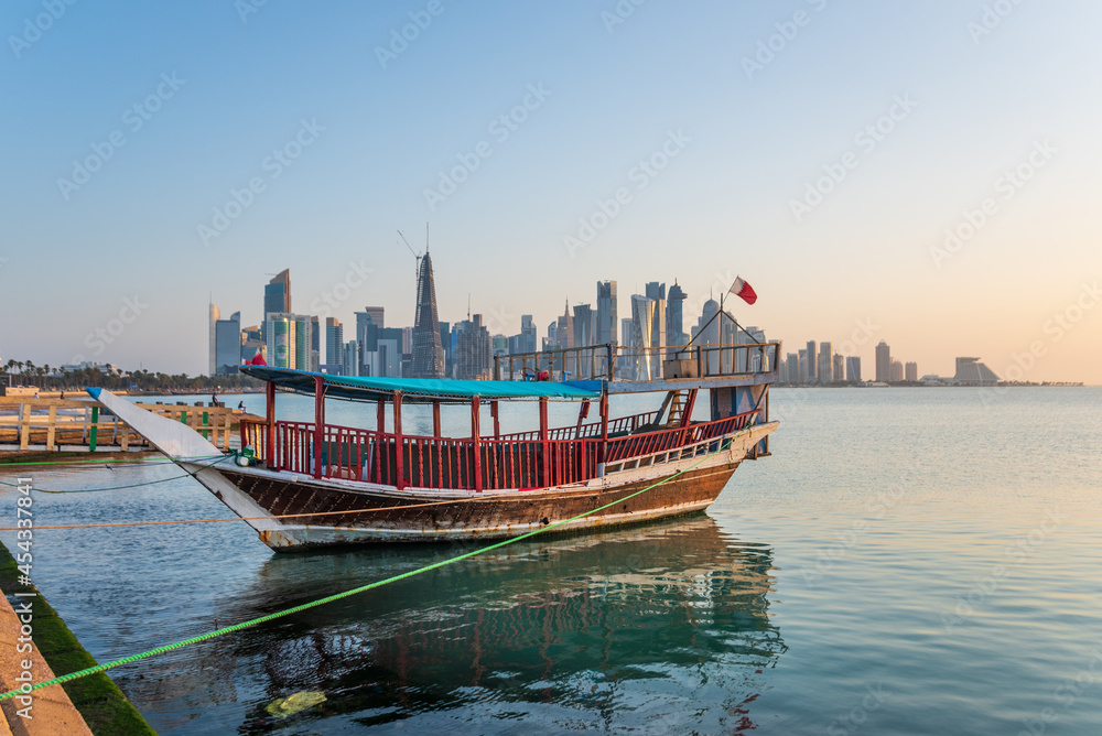Traditional dhow on a background of a modern city of West Bay Doha, Qatar.