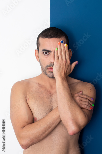 gay man rainbow colored nails, no shirt