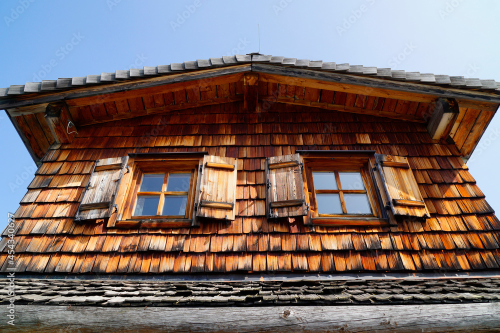 a traditional rustic wooden house with shingles in Styria or Steiermark in the Austrian Alps (Schladming-Dachstein region, Austria)