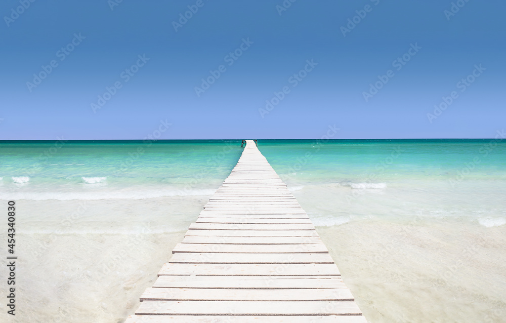 Pier on the azure sea - the concept of a holiday paradise, white sand and turquoise water