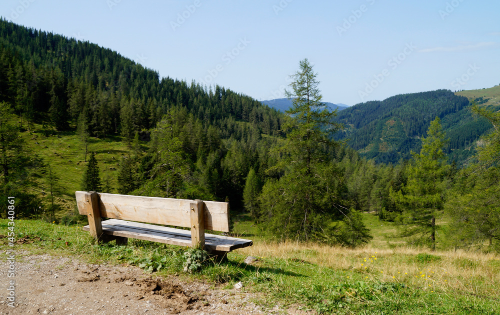 a wooden bench in the Austrian Alps in the Dachstein region (Austria)
