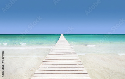 Pier on the azure sea - the concept of a holiday paradise, white sand and turquoise water