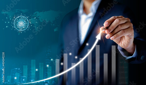 Businessman hand working draw on point arrow graph economic growth success chart. Analysis strategy data digital communication online connection. Business finance technology and marketing concept.